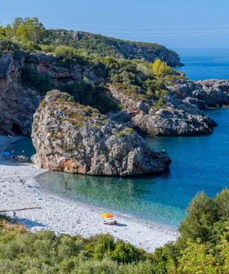 Dive into the crystal-clear waters of Foneas Beach _ WanderLife Greece